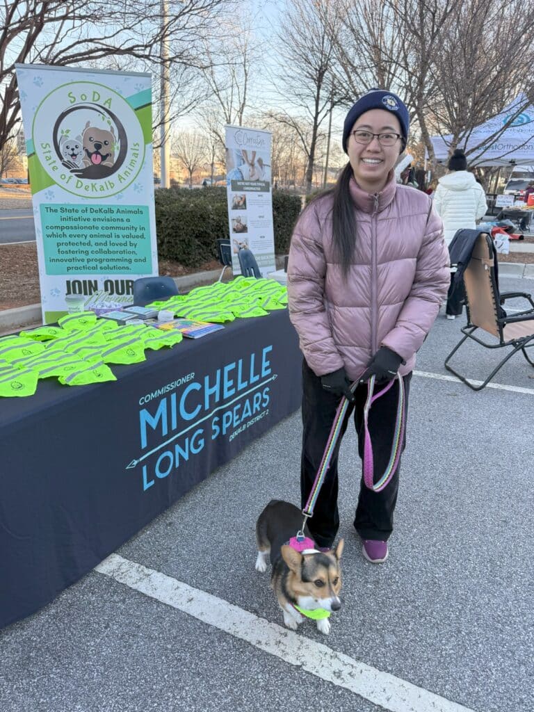 Community members visit our table at Run with the Dogs 5k and Puptrot